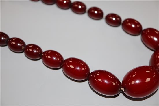 A single strand graduated simulated cherry amber bead necklace, 72cm, gross 61 grams.